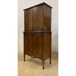 A mahogany cocktail cabinet in the Georgian taste, with two doors enclosing a satinwood interior