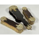 A walnut set of three brass mounted clothes and hair brushes, ( largest L x 30cm) (3)