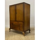 An early 20th century walnut gentlemans compactum wardrobe, two doors enclosing an interior fitted