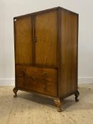 An early 20th century walnut gentlemans compactum wardrobe, two doors enclosing an interior fitted