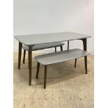 A contemporary dining table, the grey top raised on stained oak tapered and splayed supports (H76cm,