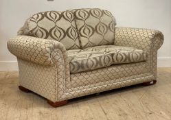 A traditional two seat sofa, in chenille type upholstery, moving on castors, H94cm, L170cm, D94cm
