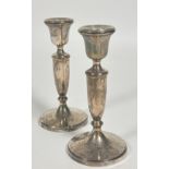 A pair of Birmingham silver baluster candle sticks raised on circular stepped weighted bases, (H x