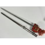 A Scottish brass hilted broadsword, the brass hilt with red felt liner and tassle, steel blade