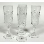 A set of four Royal rock crystal floral cut champagne flutes on ball pattern stem and plain foot, (H