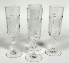 A set of four Royal rock crystal floral cut champagne flutes on ball pattern stem and plain foot, (H