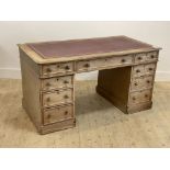 A late Victorian bleached mahogany twin pedestal desk, the top inset with tooled skiver over one