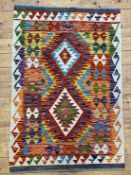 A Chobi kilim rug of all over geometric design with a running dog border 123cm x 82cm