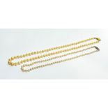 A cream coloured cultured graduated stand of pearls with oval ribbed 9ct gold clasp fastening, (L