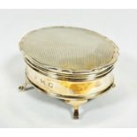 A Birmingham Mappin & Webb silver oval engine turned ring box with engraved initials F.M.G raised on