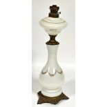 A late 19thc continental milk glass floral swag decorated baluster oil lamp base with cast brass