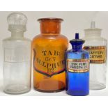 A group of four glass apothecary jars of various colours (clear, blue, tobacco) (tallest h- 27cm)