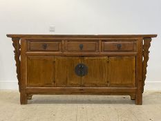 A Chinese hardwood hall sideboard, fitted with three drawers over bi-fold cupboards, raised on stile