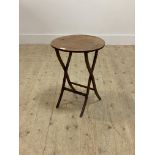 A small Edwardian mahogany coaching table, the circular folding top raised on slender supports H53cm