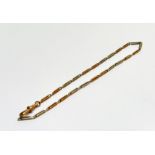 A 9ct two coloured gold guard chain with lobster claw fitting, (L x 31cm) 9.46g