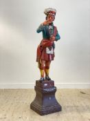 A large floor standing fibreglass statue modelled as a highland soldier, standing on a plinth base