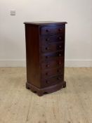A Victorian style mahogany bow front chest fitted with seven drawers, raised on bracket supports