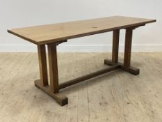 An Arts and Crafts period oak refectory type dining table, the recatangular top raised on four
