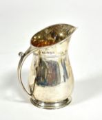 A Sheffield silver gilt ewer shaped milk jug of baluster form on circular moulded base, (H x 9cm x D
