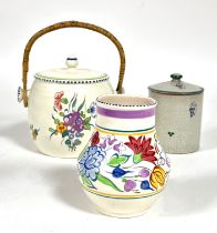 A Poole pottery 1930's biscuit barrel with wicker loop handle and floral sprays, (H x 16cm), a