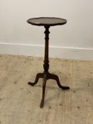 A Georgian style mahogany tripod wine table, early 20th century, the scalloped top above ring turned
