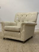 G-Plan, a mid century K'ang easy chair, upholstered in buttoned ivory damask, moving on castors,