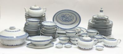 A large blue and white dinner service, with rice grain and dragon scene decoration comprising a