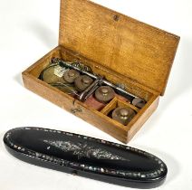 A 19thc black paper mache Abalone shell inlaid oval spectacle case with blue velvet lined