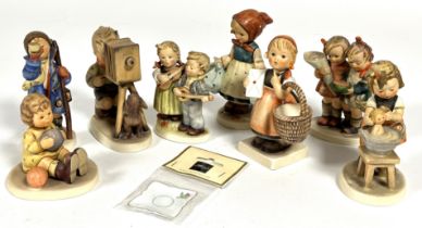 A collection of eight Hummel German pottery figures including, Doll Bath, Hear Ye, Hear Ye, etc