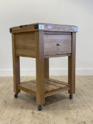 A contemporary oak butchers block style kitchen work table, with lift of tray top over a drawer,