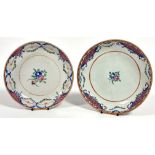 A near pair of Chinese late 19thc porcelain export ware dishes with Famille Rose decoration and