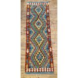 A Chobi kilim rug of geometric design with four lozenge medallions 212cm x 66cm