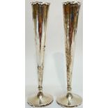A pair of Sheffield hallmarked silver spill vases by Walker and Hall, of slender/tapered form, the