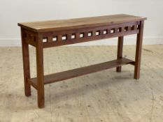 A contemporary stained teak console table, with slatted frieze raised on square section supports