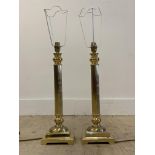 A pair of cast gilt brass table lamps of architectural column form, on square bases, H50cm