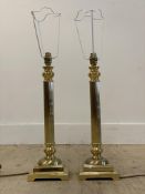 A pair of cast gilt brass table lamps of architectural column form, on square bases, H50cm