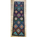 A Maimana kilim runner with repeating lozenges on a dark field 208cm x 61cm