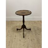 An Edwardian mahogany tripod table in the Regency style, the inlaid circular dished top with