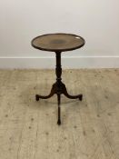 An Edwardian mahogany tripod table in the Regency style, the inlaid circular dished top with
