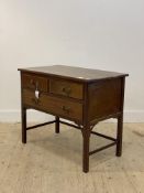 An Edwardian mahogany side table, fitted with two short and one long drawer, raised on moulded