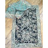 Two Crewel work wool embroidered wall handing tapestries, one with floral motifs on a black