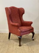 A late 19th century oak framed Wingback chair of 18th century design, upholstered in pink damask,