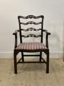 A 19th century mahogany fiddle back elbow chair, the back rails with anthemion motif over acanthus