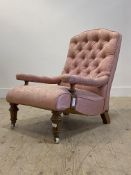 A Victorian walnut framed open armchair, upholstered in buttoned pink damask, raised on turned and