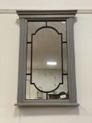 A traditional grey painted hardwood wall hanging mirror, with fluted pilasters flanking a mirrored