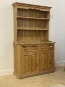 A Victorian style pine dresser, the two height plate rack over base fitted with two drawers above