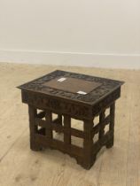 A Small chinese folding stool, late 19th / early 20th century, the top with incise carved border