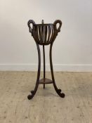 A Victorian style mahogany jardiniere stand, the scrolling supports carved with swans H107cm