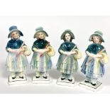 Katzhutte, a group of four porcelain figures of girls with bonnets holding baskets of flowers,