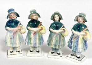 Katzhutte, a group of four porcelain figures of girls with bonnets holding baskets of flowers,